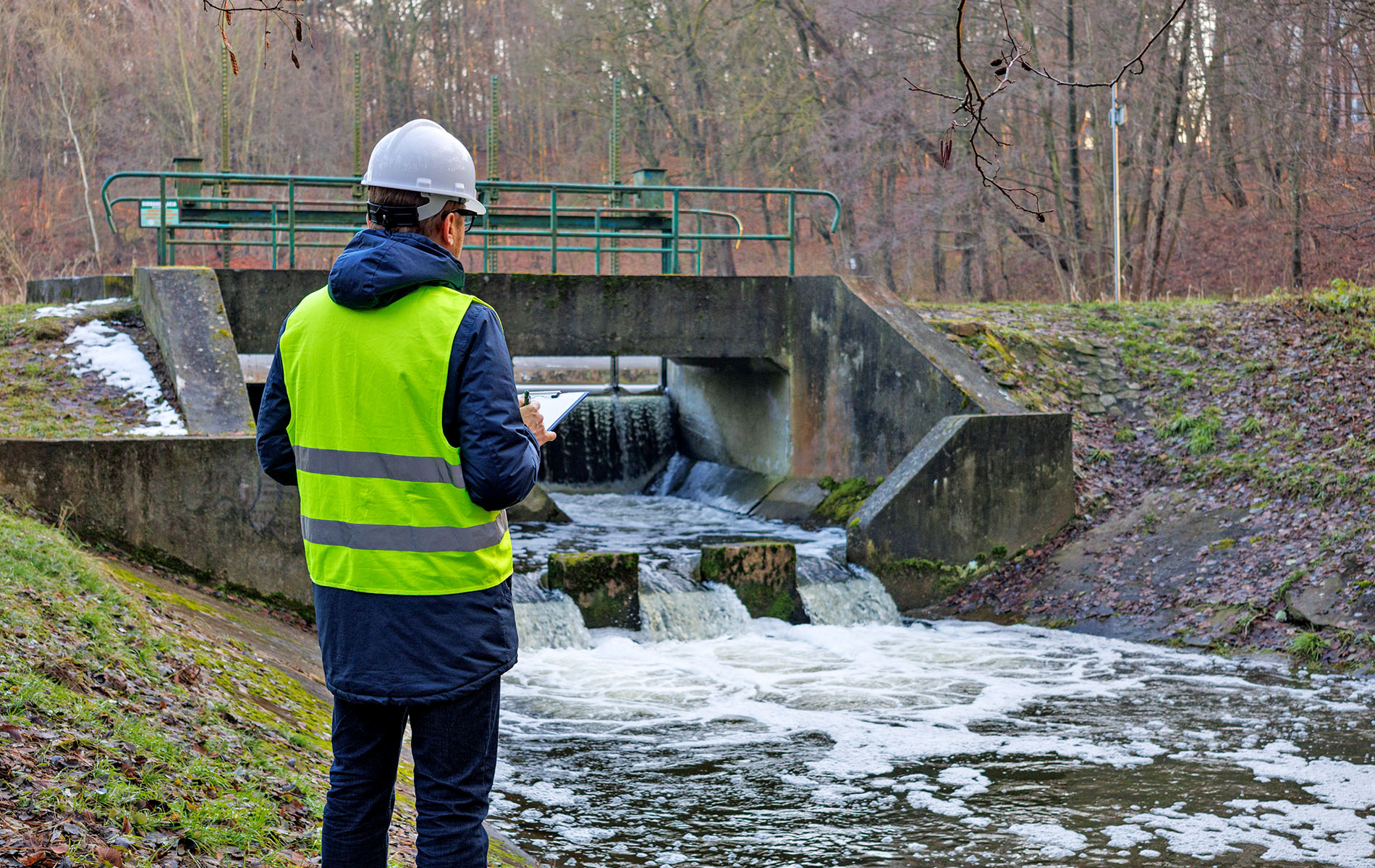 utility service provider testing water at river